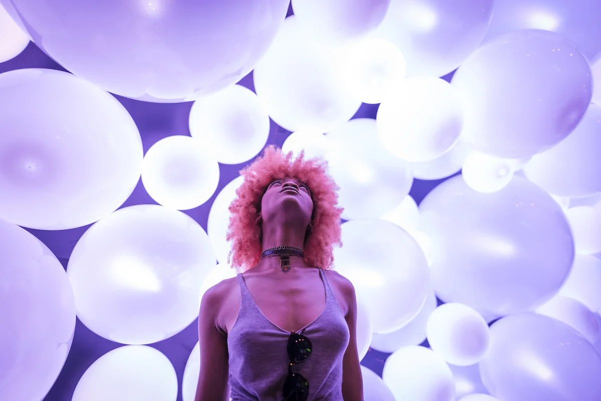 A visitor framed by glowing white forms