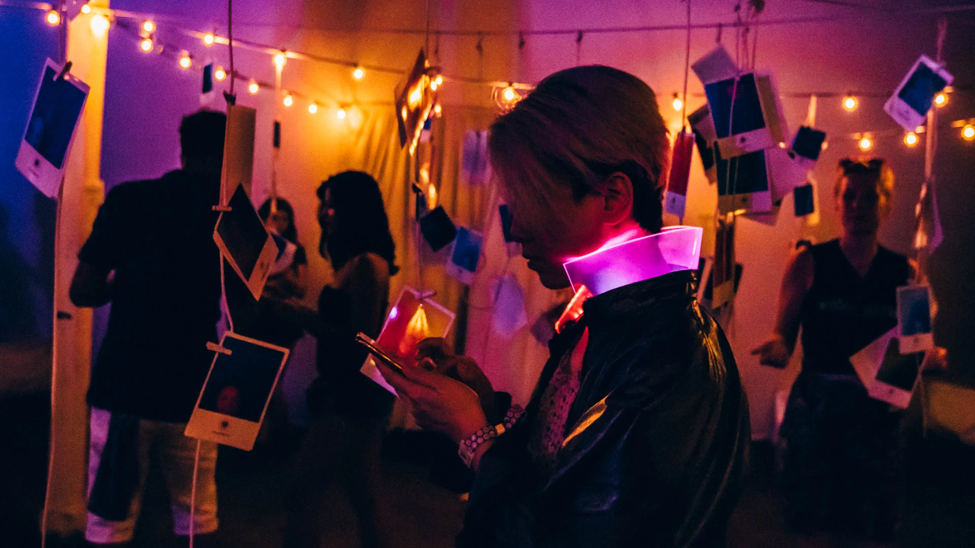 Visitors moving through a warm-lit installation