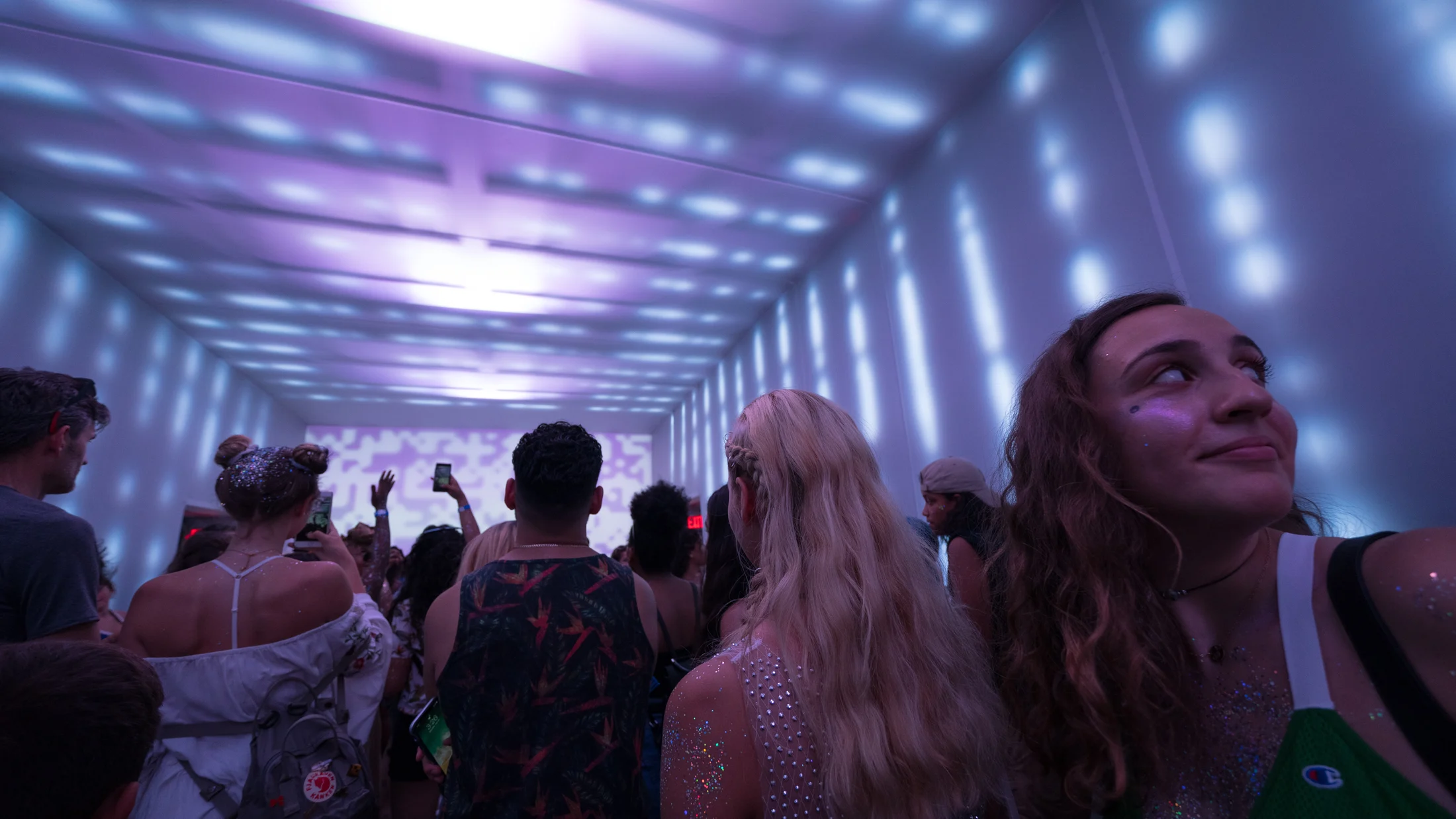 Visitors among a canopy of illuminated strands
