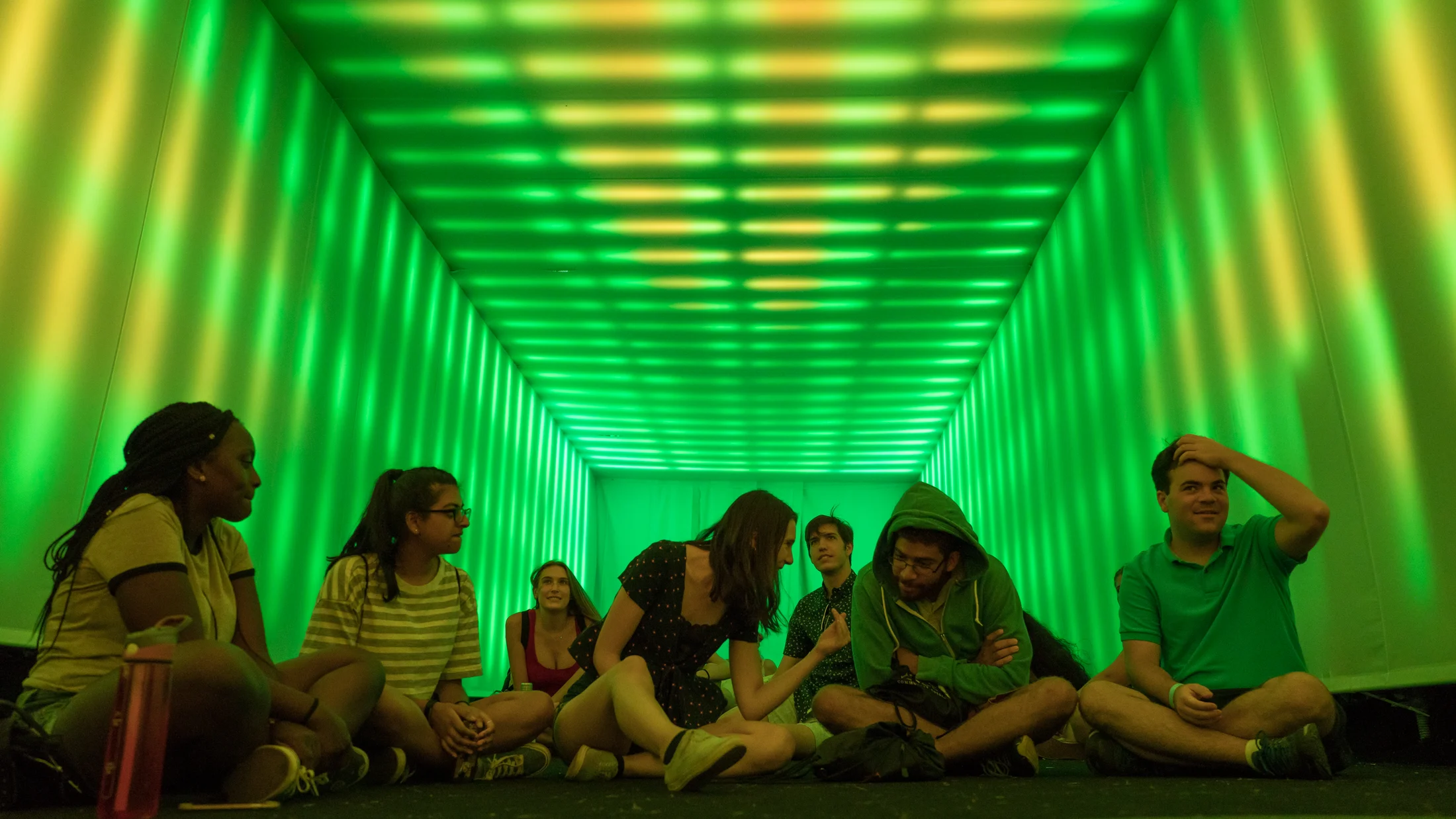 A visitor crossing a vividly projected floor